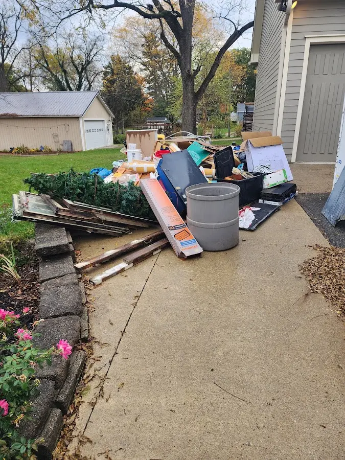 Dumpster being loaded with debris for Estate Cleanout Dumpster Rental in Harrisville